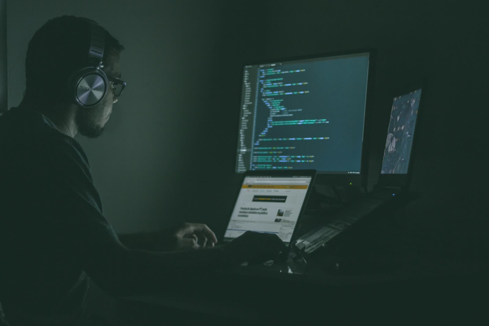 IT engineer monitoring security dashboards at night as part of outsourcing IT support