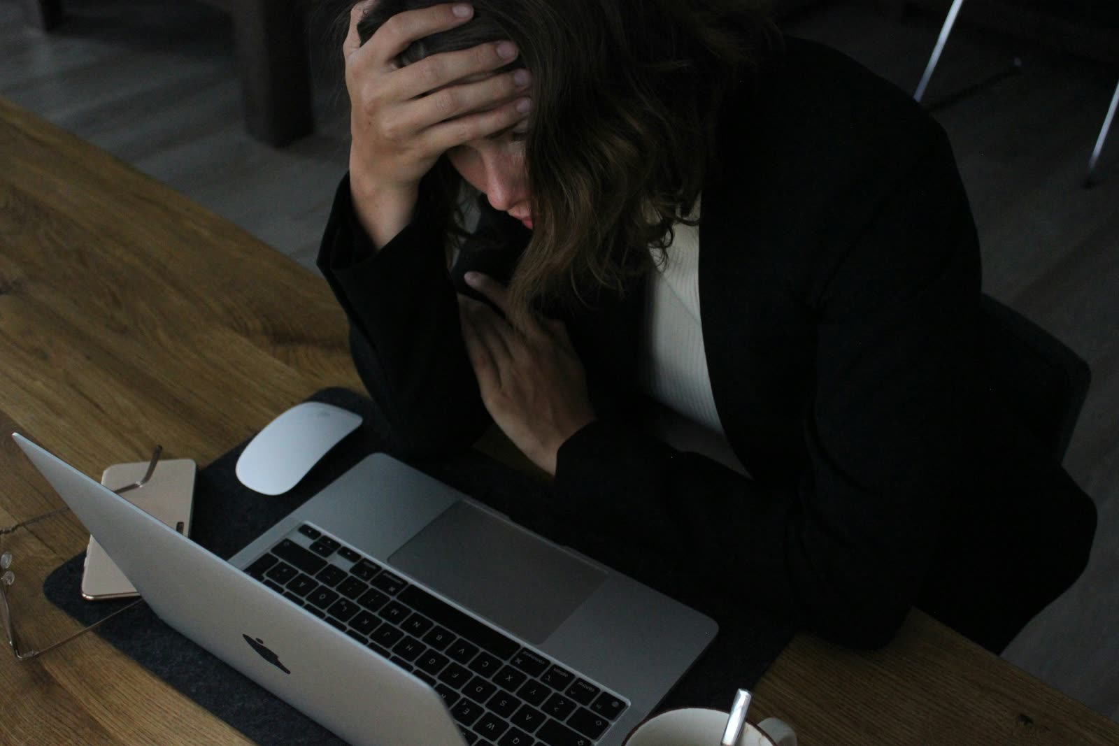 Stressed business owner at laptop before outsourcing IT support